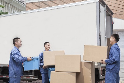 Professional movers handling office equipment in a Yiewsley commercial area