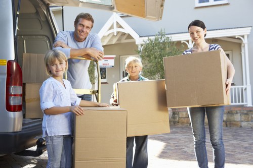 Packed office boxes and labelled equipment for relocation