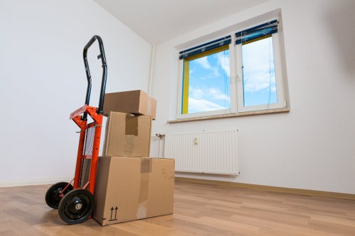 Packed boxes and furniture being loaded into a removal van
